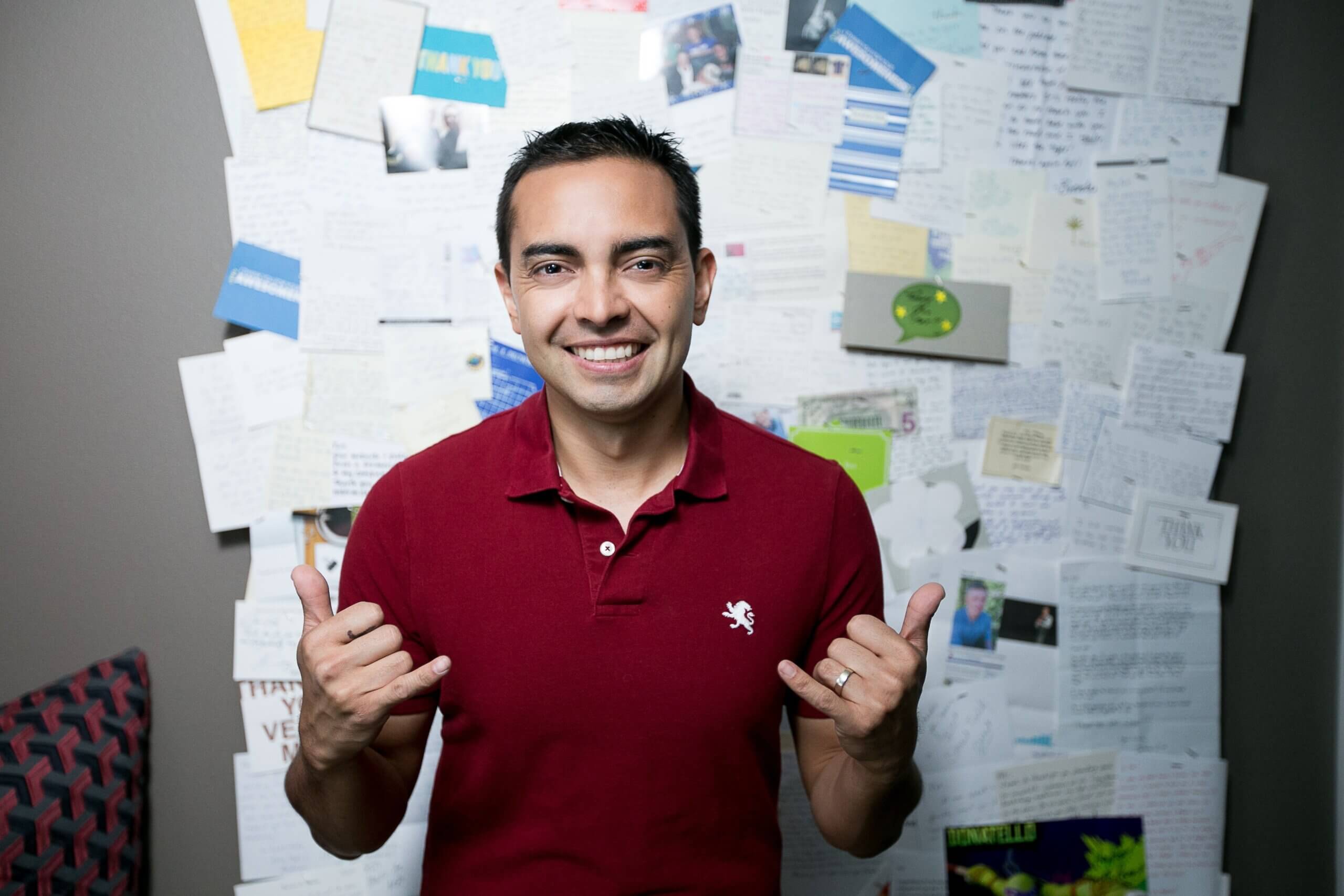 Photo of Pat in front of a board filled with thank you notes.