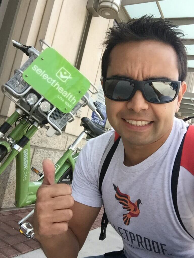 A picture of Pat with a green rental bicycle