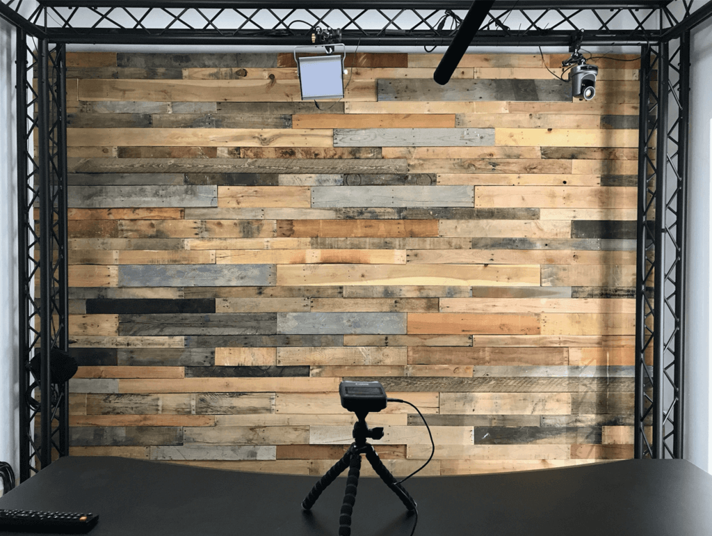 Photograph of the video backdrop, with a reclaimed wood plank background