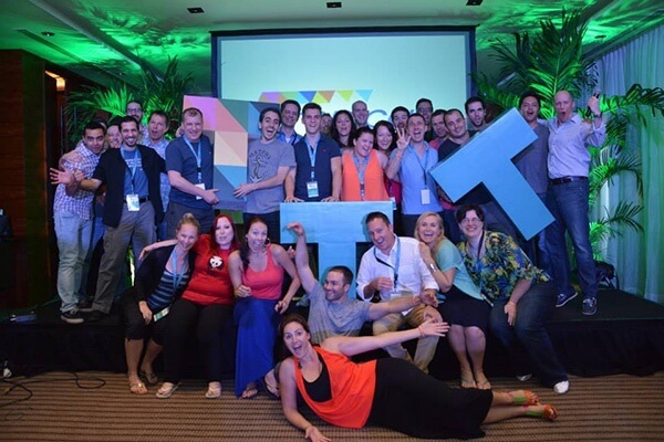 Tropical Think Tank group photo with 30 people holding three large letter Ts