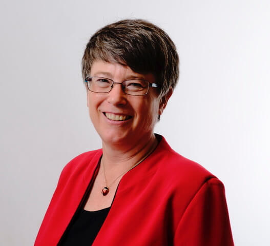 Headshot of Trudy Rankin in a red suit