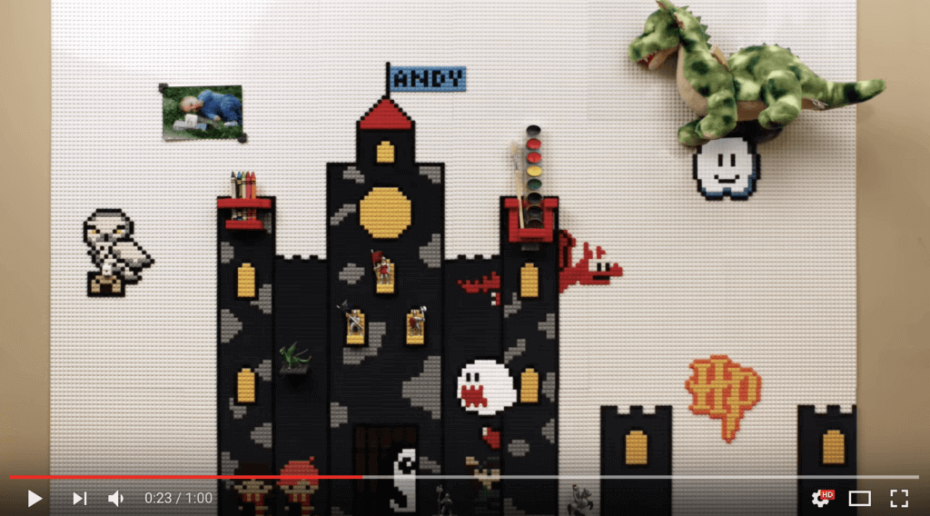 Screenshot of video with 23 seconds of 60 played. It shows a series of tiles with LEGO making a Mario castle, a Harry Potter owl, and a photograph help up with LEGO.