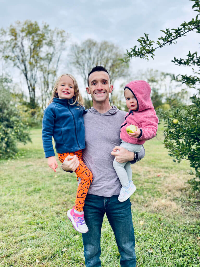 Matt holding his two daughters