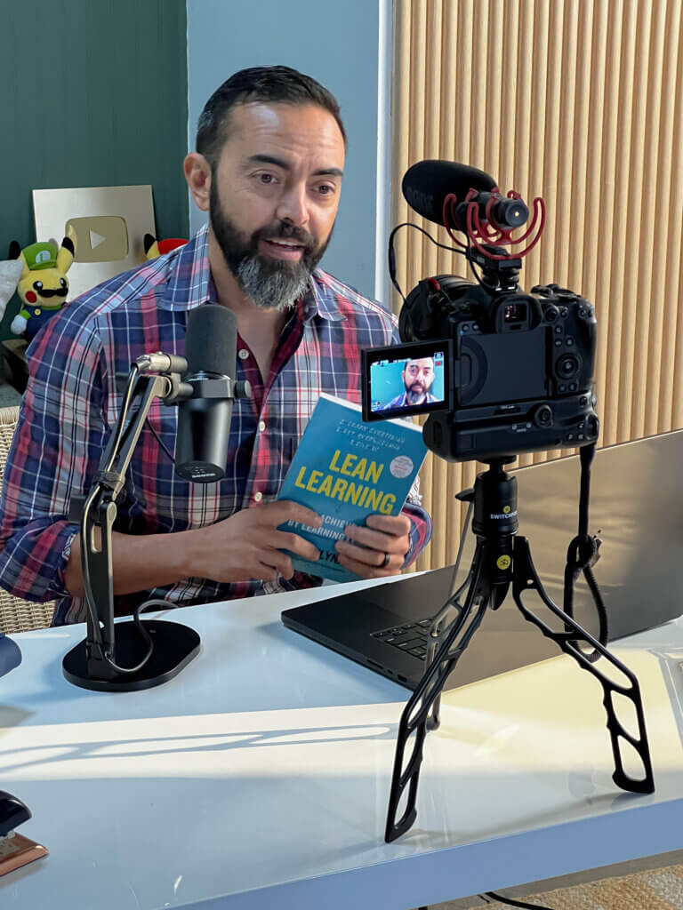 Pat filming with his book Lean Learning