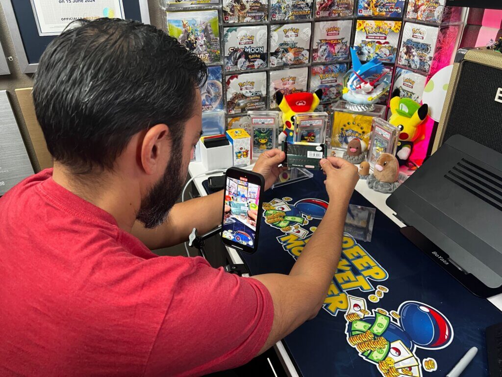 Image over the shoulder of Pat Flynn as he films short-form videos for his Pokeman card channel, Deep Pocket Monster