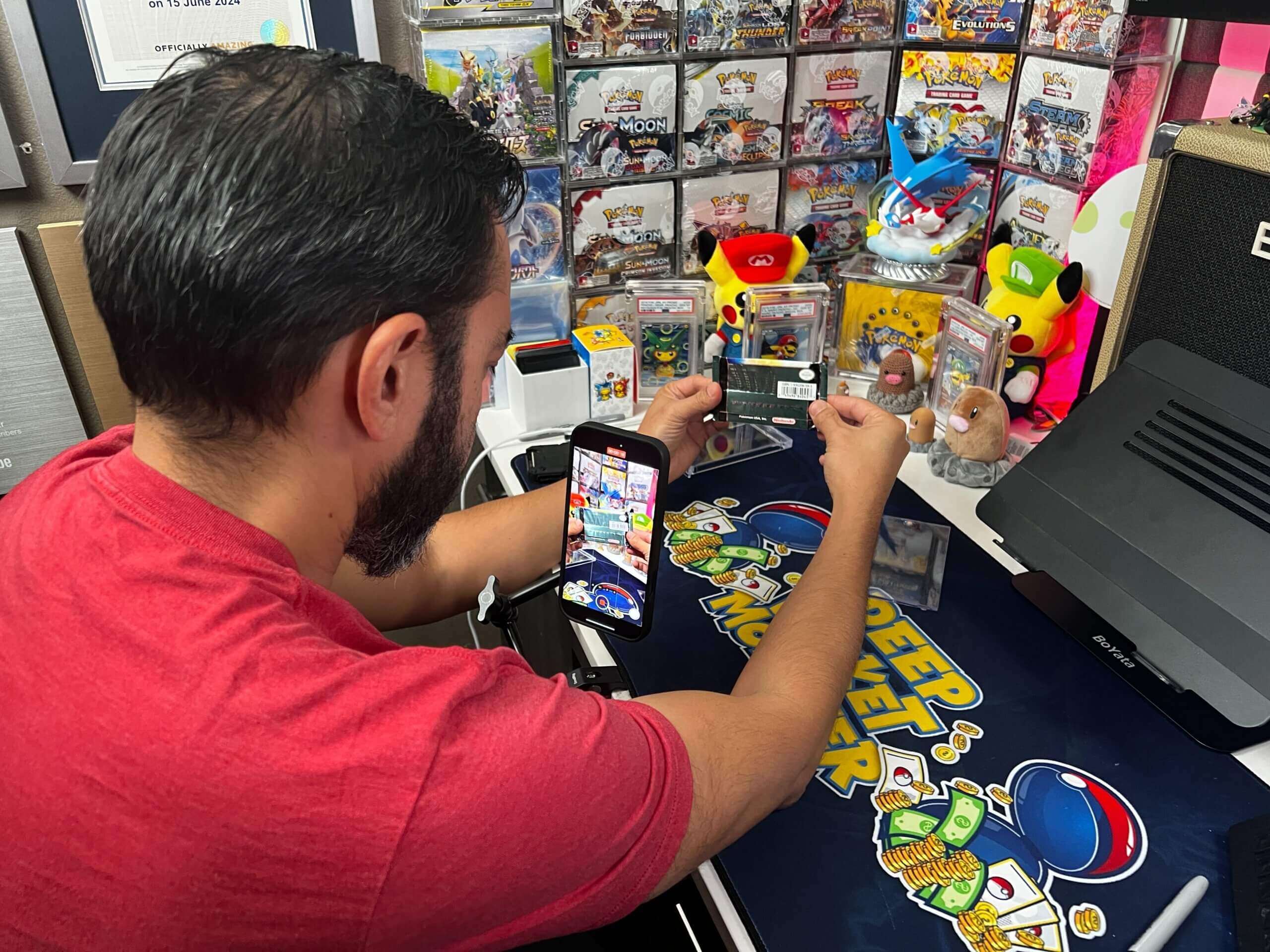 Image over the shoulder of Pat Flynn as he films short-form videos for his Pokeman card channel, Deep Pocket Monster