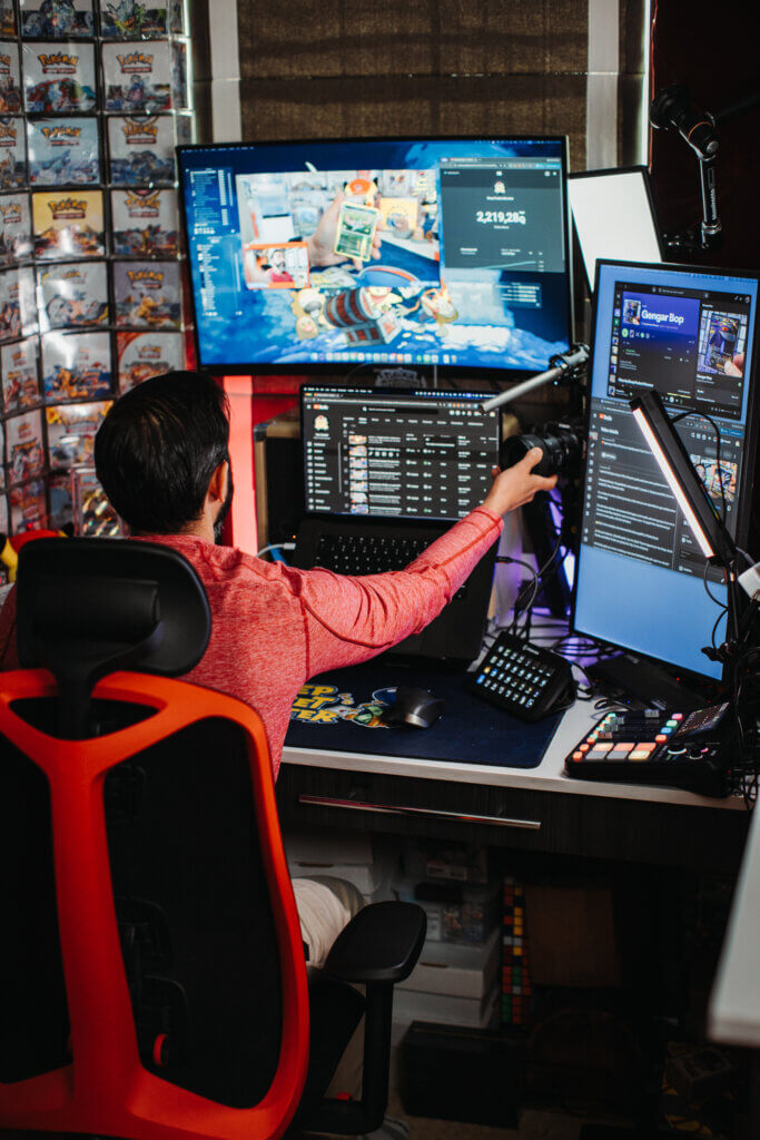 Behind the scenes photo of Pat using Ecamm for a Pokemon card opening live stream